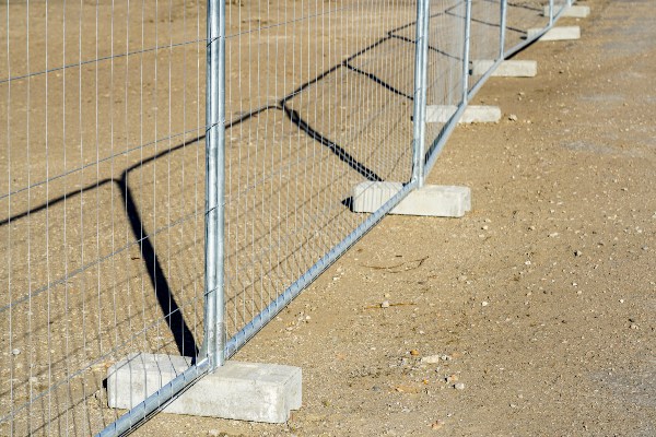 Temporary fence with concrete blocks installed on dirt for various needs in Rancho Cordova, CA
